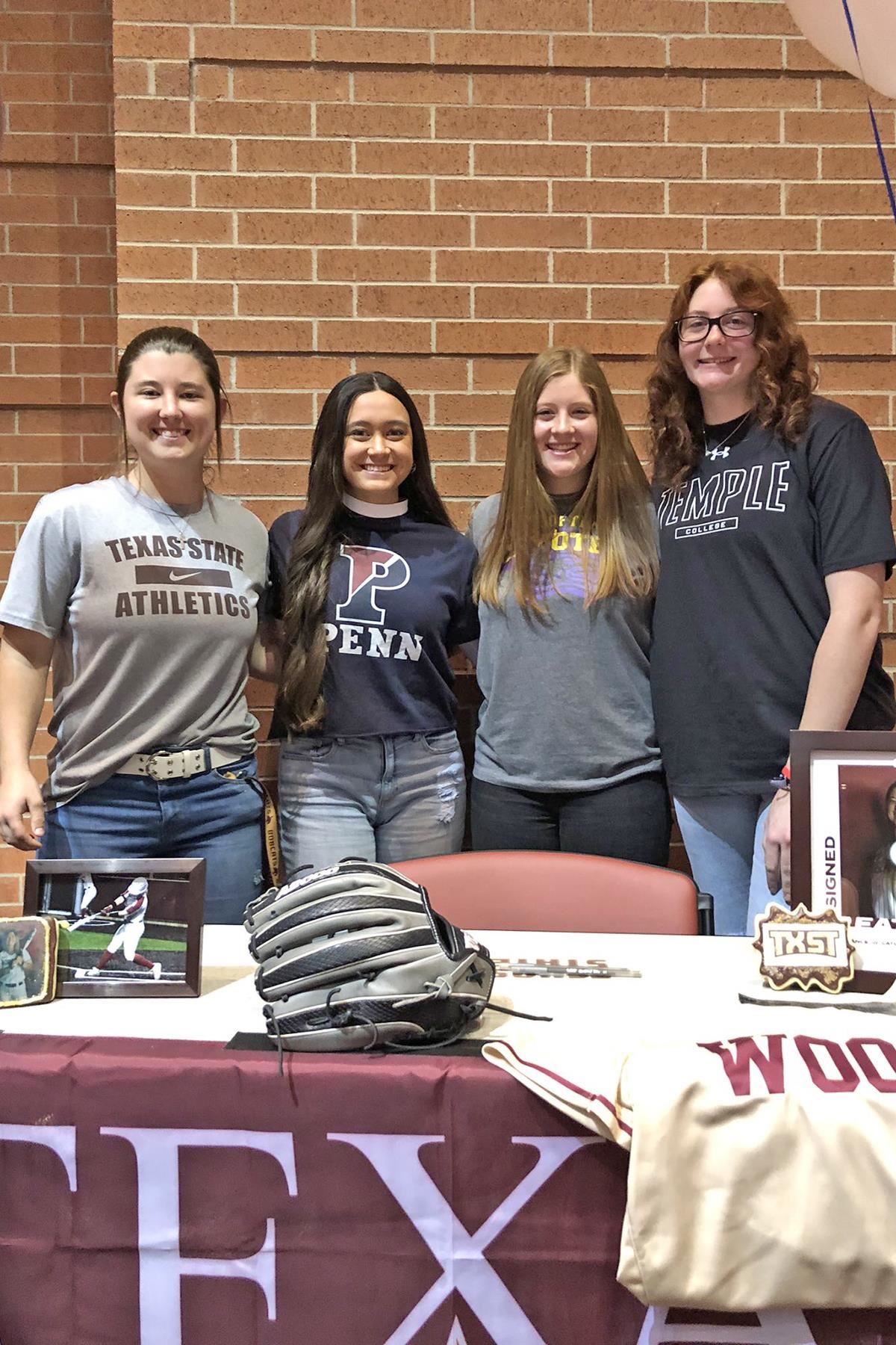 Four Cypress Woods High School senior softball players pose for photos at the school’s signing day ceremony on Feb. 1.